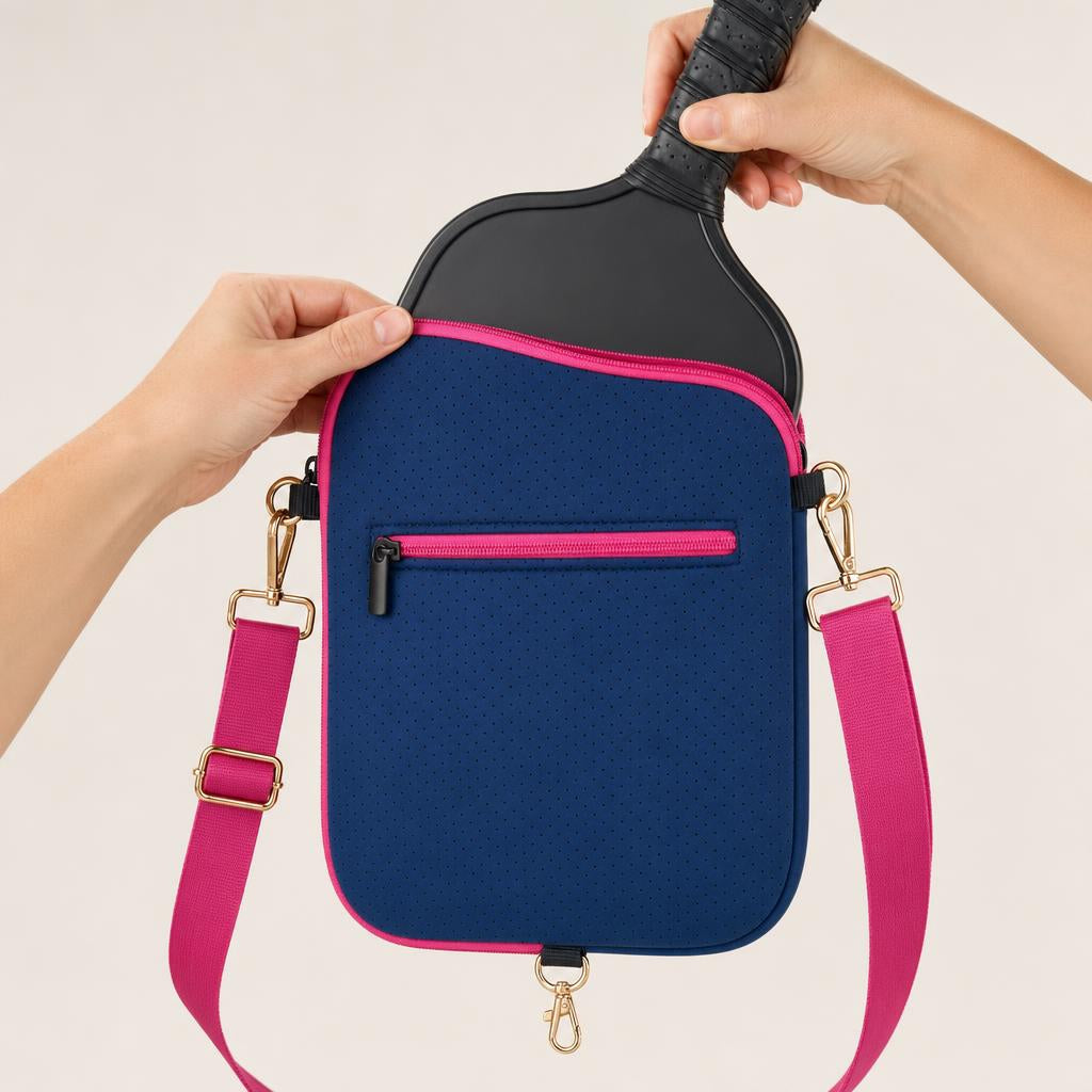 Hands sliding a paddle into the navy blue CARRY cover