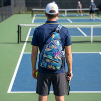 Player seen from behind with the tropical RALLY backpack worn on one strap