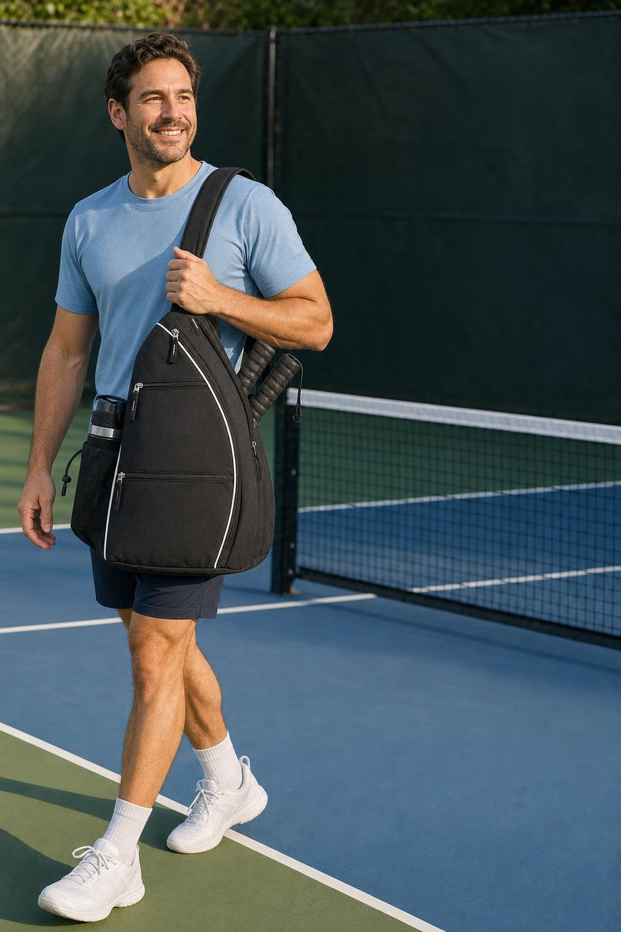 Player arriving at the pickleball court with the black RALLY backpack slung over one shoulder