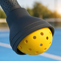 Close-up of the silicone mouth of the SCOOP ball pickup tool holding a yellow pickleball